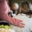A person in a pink sweater gently rests a hand on another person's shoulder in a comforting gesture, capturing the warmth and connection at South Shore Resort and Retreats, ideal for a peaceful retreat or Lake Michigan getaway.| South Shore Resort & Retreats in West Michigan