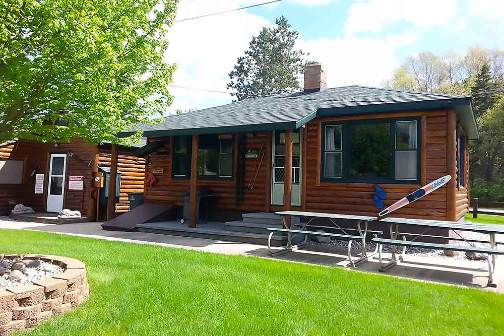 huron-cabin-final Huron Cabin exterior with wood burning fireplace and lake views at South Shore Resort & Retreats Twin Lake Michigan